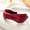 Detailed view of wine red wide knotted satin headband for women, elegant daily hair accessory. - Red