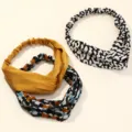 Detailed view of wide cross satin elastic headbands, smooth fabric texture and comfortable fit. - Multicolor