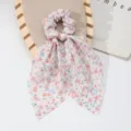 Detailed view of a French style floral hair scrunchie with long ribbon bows for women. - Pink & Blue Floral