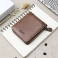 Vista dettagliata del portafoglio corto da uomo in pelle cerata marrone con zip sicura. - Caffè Chiaro