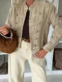 Close-up of military-style khaki cropped jacket with decorative metal buttons and long sleeves. - S / Tops / Khaki