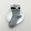Grey mid-calf socks featuring navy striped trim with cute white pom-poms and a small stylish label. - One Size (35-39) / Fabric Label