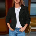 Detailed view of the stylish black blazer featuring classic lapels and double-breasted buttons. - S / Tops / Black
