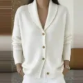 Detailed view of women's cozy knit cardigan, shawl collar, long sleeves, button down style. - White