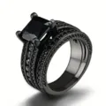 Detailed close-up of a gothic black multi-band ring set with a square black main stone. - US 10 / Black Gold Black Stone