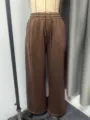 Closeup of brown fleece-lined wide-leg sweatpants, elastic drawstring waist, cozy winter style. - XS / Bottoms / Coffee