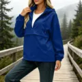 Outdoor blue hooded anorak jacket detail view, featuring half zipper and comfortable fit. - S / Tops / Blue