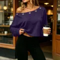 Detail view of the stylish purple off-shoulder top featuring metal eyelet neckline and sleeves. - Purple