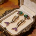 Vintage fish skeleton earrings with pearls and gold tone metal, retro court style fashion jewelry. - Fish Bone Dangle Earrings / Gold