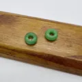 Green jadeite donut beads detail shot, smooth polish texture, perfect for DIY jewelry making accessories. - Malaysian Jade