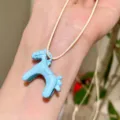 Detailed close-up shot of the cute blue enamel 3D horse pendant necklace accessory. - Blue Pony Pendant Necklace