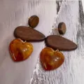 Close-up detail of stylish wooden and amber resin heart drop earrings, retro design. - Brown Texture Heart Pendant