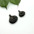 Close-up of polished gemstone magatama pendants, smooth drilled stone DIY accessories. - Smoky Quartz
