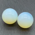Close-up detail of two smooth translucent crystal spheres, perfect for home decor display and teaching. - Opal