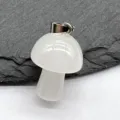 Close-up of a mini white crystal mushroom pendant with metal bail on slate detail view. - 1pc White Jade Stone