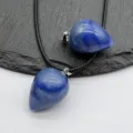 Close-up detail of blue drop-shaped crystal stone pendant with black cord necklace. - Blue Aventurine