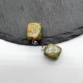 Close-up detail of natural gemstone square pendant with metal bail on slate background. - Unakite (1 Piece)