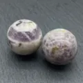 Detailed close-up of natural crystal stone sphere, polished purple mineral decor specimen. - Striped Amethyst