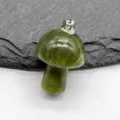 Close-up of a green jade stone mushroom pendant with silver bail, natural gemstone detail view. - Green Banded Stone (1pc)