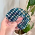 Detail view of the unique blue plaid hair claw clip, showing its clear acrylic texture. - B Geometric U-Shaped Hair Claw