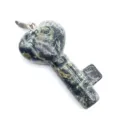 Close-up detail of the heart-shaped key stone pendant showing natural green texture. - Rhyolite