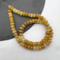 Close-up detail of natural gemstone abacus beads, smooth cut for DIY jewelry making accessories. - Yellow Stone