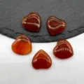Detailed close-up of polished red crystal heart gemstones, smooth non-perforated crystal. - Red Agate