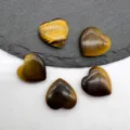 Detailed shot of polished tiger eye heart gemstone crystal decor, smooth surface, beautiful piece. - Tiger's Eye