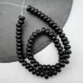 Detailed close-up of black abacus beads spacer strand, ideal for DIY jewelry making. - Obsidian