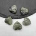 Detailed view of natural crystal heart shaped gemstone pendants, polished non-perforated healing stones. - Labradorite