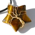 Close-up detail of tiger eye star pendant with wire wrapped tree of life design gemstone. - Tiger's Eye