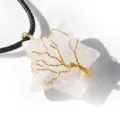 Primo piano del ciondolo a stella in cristallo bianco con albero della vita in filo d'oro. - Cristallo di rocca