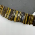 Natural tiger eye stone rectangular tube bead detail closeup shot for DIY jewelry making. - Tiger's Eye