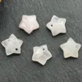Close-up detail of faceted rose quartz star pendants with drilled holes for DIY jewelry making. - Rose Quartz