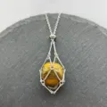 Stainless steel cage pendant necklace featuring a natural tiger eye crystal stone. Adjustable. - Silver-Tiger's Eye