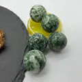 Detail view of polished natural green stone spheres, 25mm crystal balls decor set. - 25mm / Blue Spot Jasper