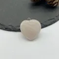 Close-up of a natural rose quartz heart pendant with silver bail for custom DIY necklaces. - Rose Quartz