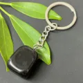 Natural black crystal tumbled stone keychain detail showing smooth polished surface and steel ring. - 15-20mm Tumbled Stone / Obsidian Keychain