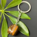Detailed view of natural tiger eye stone tumbled gemstone pendant with stainless steel keychain. - 15-20mm Tumbled Stone / Tiger's Eye Keychain