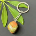 Close-up detail of natural gemstone tumbled stone keychain with stainless steel ring and chain. - 15-20mm Tumbled Stone / Unakite Keychain