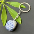 Close-up of polished natural crystal stone pendant and stainless steel keychain detail. - 15-20mm Tumbled Stone / Blue Spot Stone Keychain