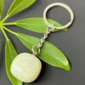 Close-up detail of the natural green crystal tumbled stone pendant and stainless steel ring. - 15-20mm Tumbled Stone / Xishan Jade Keychain