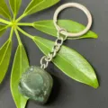 Close-up detail of natural green crystal tumbled stone keychain with durable stainless steel ring. - 15-20mm Tumbled Stone / Indian Agate Keychain