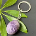 Close-up detail of natural amethyst tumbled stone keychain with stainless steel ring for keys. - 15-20mm Tumbled Stone / Amethyst Keychain
