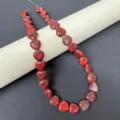Close-up detail of natural red heart gemstone beads strand, perfect for DIY jewelry making. - Red Jasper