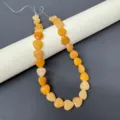 Close-up detail of 12mm natural stone heart gemstone beads, perfect for DIY jewelry making. - Yellow Jade Strand