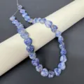 Close-up detail of 12mm natural blue stone heart beads strand for DIY jewelry making. - 1 Strand Blue Spot Jasper