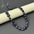 Detail view of blue sandstone heart beads strand for DIY jewelry making and necklace accessories. - Synthetic Blue Goldstone
