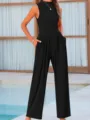 Detail shot of women's sleeveless black jumpsuit featuring loose wide leg pants and pockets. - XS / Jumpsuits / Black