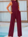 Detailed view of the elegant burgundy sleeveless wide-leg jumpsuit featuring practical side pockets. - XS / Jumpsuits / Burgundy